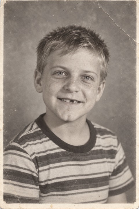 A boy of about seven in a black and white school portrait