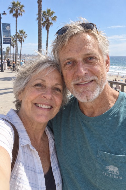 At seventy, a selfie with his wife by the ocean